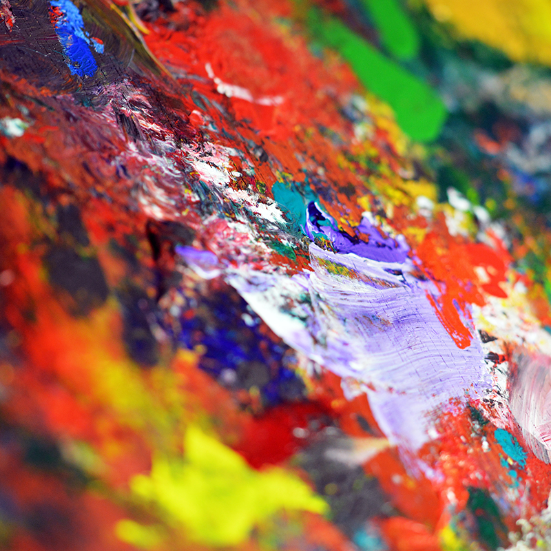 Close up photo of a messy paint palette